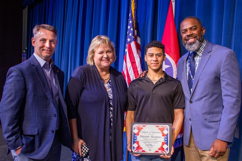A student is honored for serving in the US Armed Forces after high school